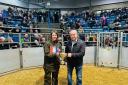 Shona Gunn is presented with the champion ticket by Eric Thomson