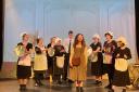 Some of the cast of Annie, with Polly Devonald playing Annie centre.