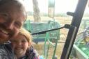 Happy days at last - Murdoch and his youngest daughter Charlotte in the cab of one of the tractors almost two months after the first combine went into the field with all but the straw bales to wrap