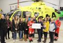 A cheque for £2000 being presented to Scotland’s Charity Air Ambulance at Hangar, Aberdeen, after a successful auction raised the funds