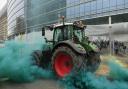 A farmer drives his tractor near the European Council building in Brussels during a demonstration of farmers, Tuesday, March 26, 2024. Dozens of tractors sealed off streets close to European Union headquarters where the 27 EU farm ministers are meeting