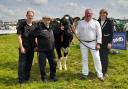 Inter-breed dairy champion, Clydeview Sidekick Matilda pictured with handler Scott McGill, Salvy Esquierdo and Robbie and Margot Scott