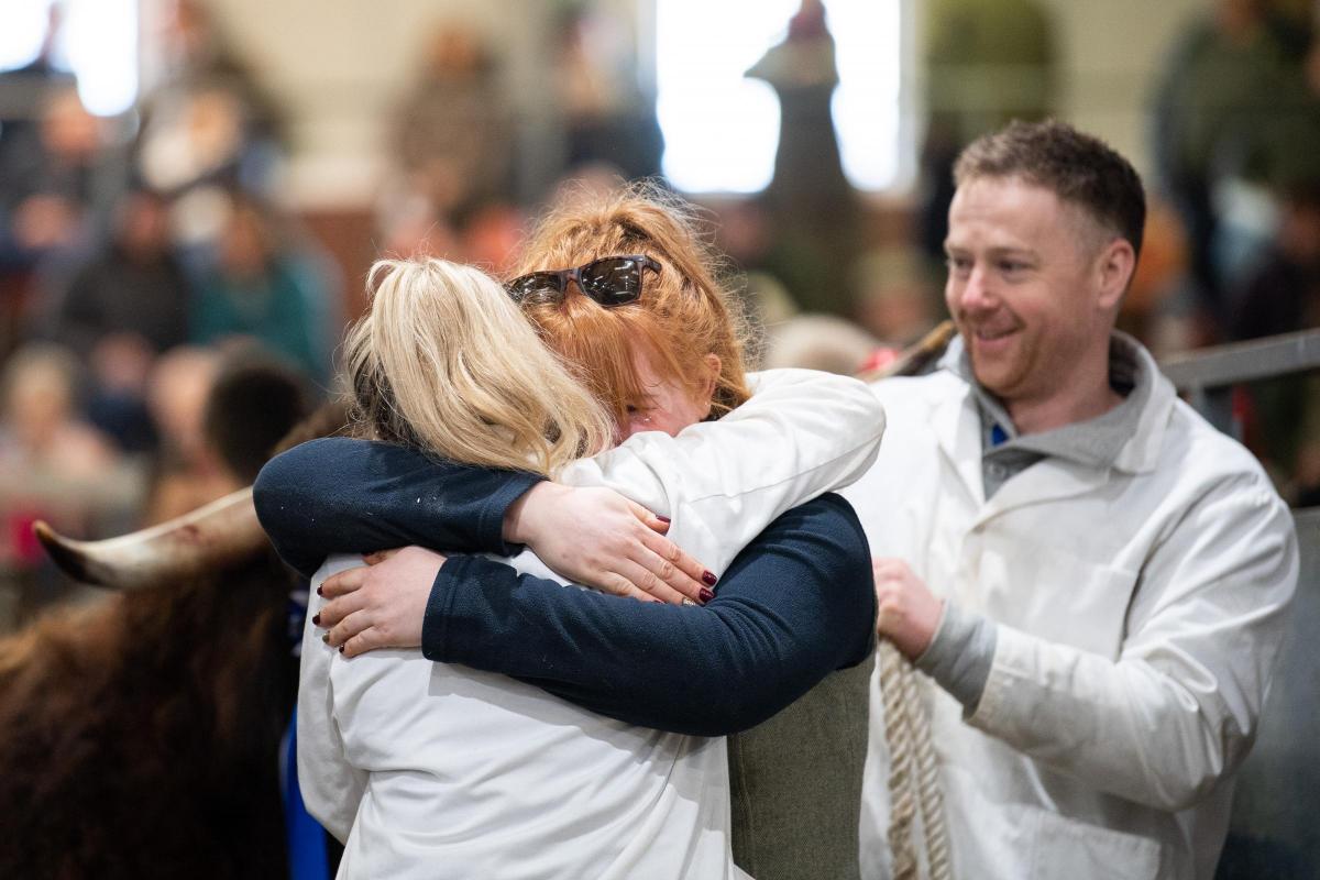 Hugs and emotional tear as Jordan Headspeath comes out the ring after selling Angus 2nd of Sorne for a new breed record of 27,000gns   Ref:RH140222053  Rob Haining / The Scottish Farmer...