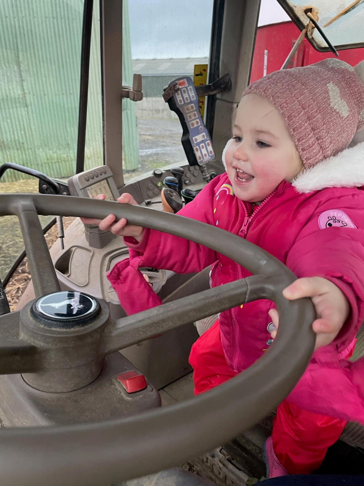 Harriet Dradge - Isla Macleod, 18 months helping her dad feed the cows