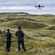 Environmental specialists use a drone to estimate carbon storage on Tiree farms
