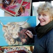 Hilary Barker with one of her trademark paintings