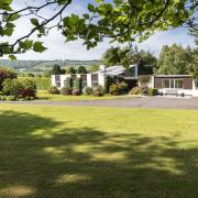 Surrounding the property is over eight acres of land, comprising expansive gardens, grazing, and woodland