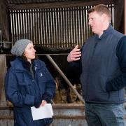 John Elliot Jr discusses on-farm emission reduction strategies with Mairi Gougeon at Roxburgh Mains. Ref:RH090124111  Rob Haining / The Scottish Farmer