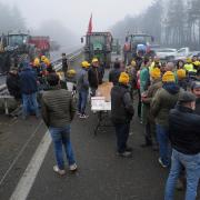 Farmers block a road near Agen, south-western France (Fred Scheiber/AP)