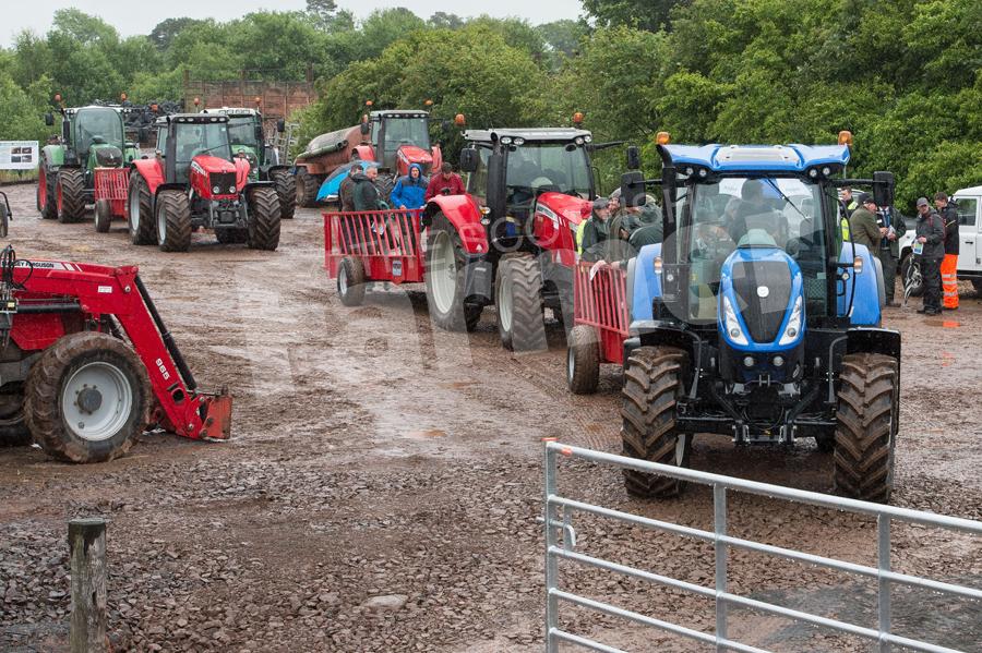 Line up of tractors and trailers ready to take people out on the farm tour. Ref: RH8617280