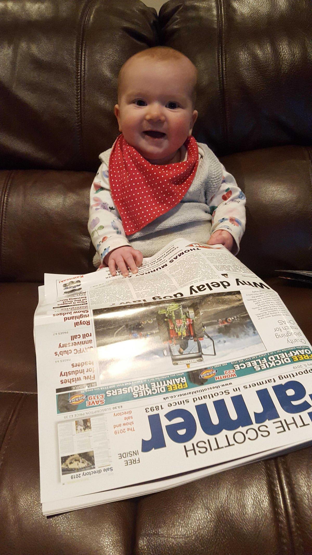 A smiling Annabele Muirhead, whi is just six months old, and lives in Somerset, pinched her daddy Jock's copy of The Scottish Farmer while he was out tending to the farm's Cheviots.