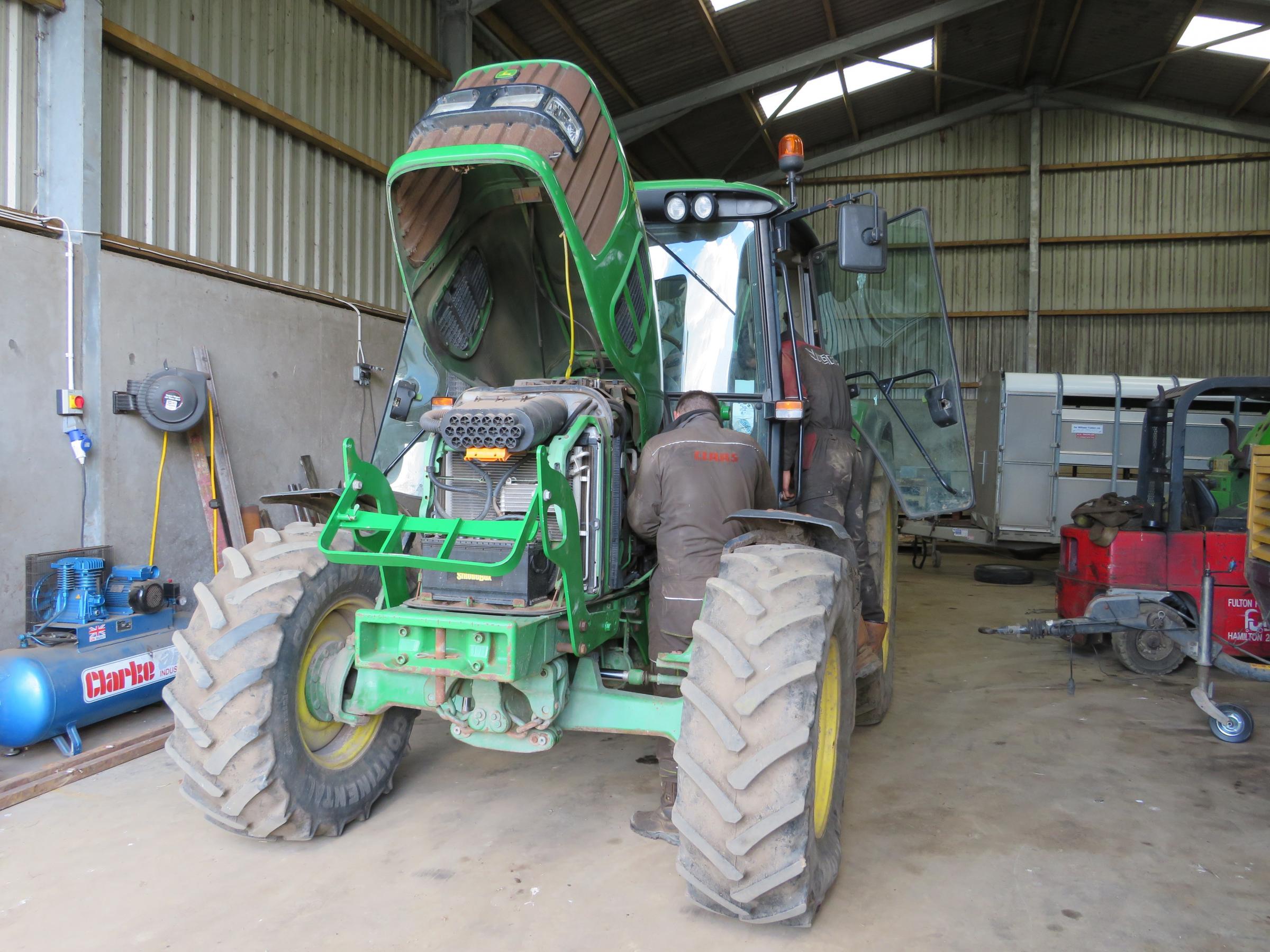 Scott and Andrew doing some repairs on a John Deere tractor