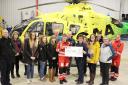 A cheque for £2000 being presented to Scotland’s Charity Air Ambulance at Hangar, Aberdeen, after a successful auction raised the funds