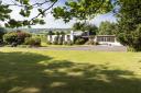 Surrounding the property is over eight acres of land, comprising expansive gardens, grazing, and woodland