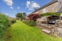 The four-bedroomed farmhouse has a particularly attractive south-facing outdoor space looking out over the Clyde valley and includes a barbecue area with pizza oven