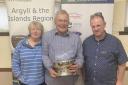 Long-serving Mid Argyll member John Semple (centre) has been awarded the prestigious Argyll and the Islands Stalwart Award for 2024 by NFU Scotland.