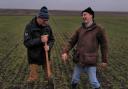 UKRAINE has long been a huge exporter of proteins and wheat, with strong links to the UK. Pictured here, in happier times, Ukraine-based Scots agronomist Dr Keith Dawson (left) shares some fun with one of his local counterparts when checking on the soil