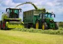 GETTING TESTED at the silage up in Caithness, a new Claas Jaguar 970, brought up by AH Mackay's West Greenland Contracting, running with their John Deere 6155r and a 14tonne Bailey trailer (Pic: Murray Coghill)