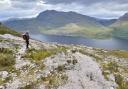 A hillwalker enjoying the view over Loch Maree from the mountain trail at Beinn Eighe National Nature Reserve, Wester Ross ©Lorme Gill/SNH
