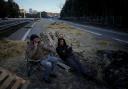 Farmers sit on a highway after spending the night at a barricade in Aix-en-Provence, southern France (AP Photo/Daniel Cole)