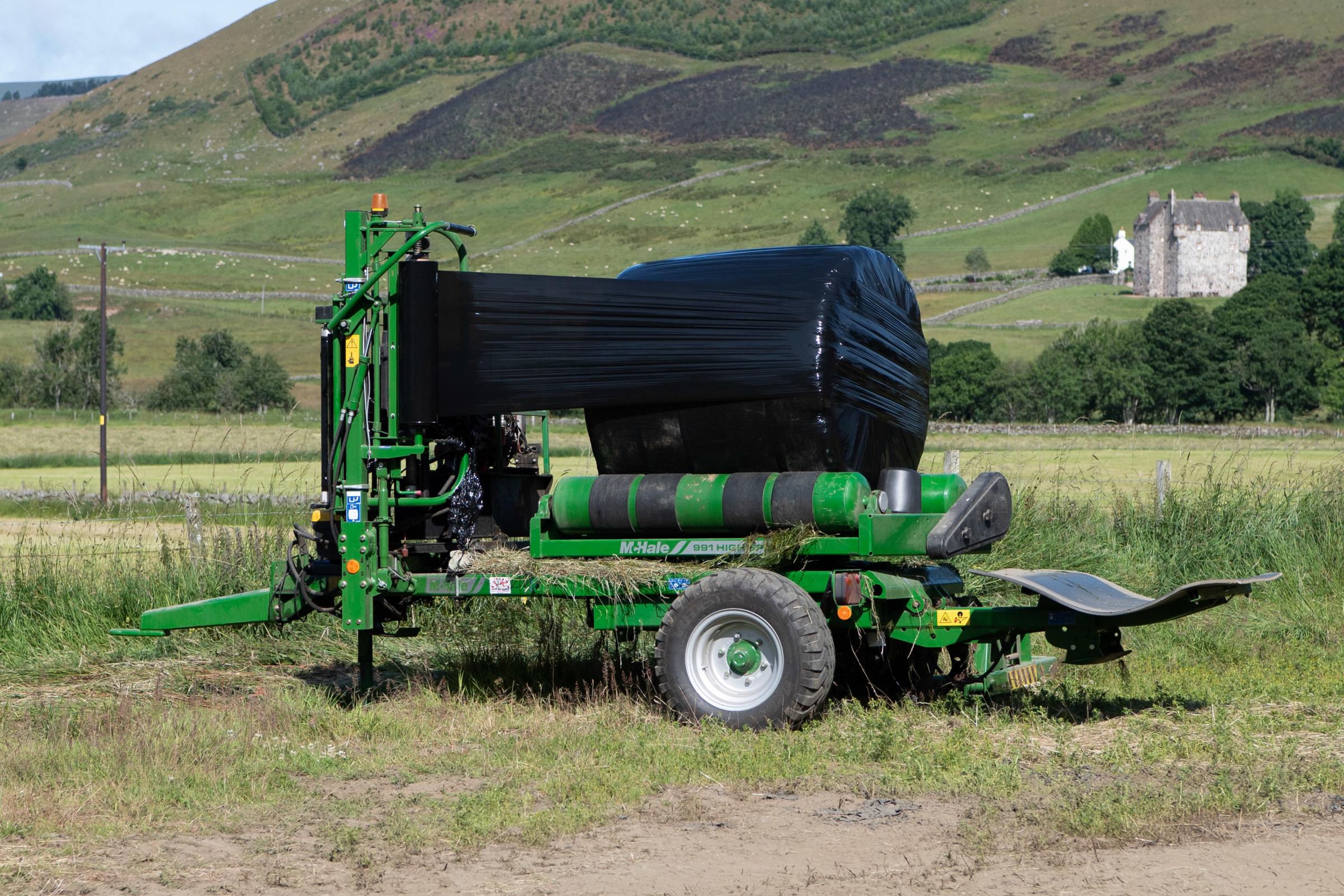McHale 991 high speed bale wrapper is used by N and R Constable for the efficient and effective round bale wrapping it does Ref:RH170721063 Rob Haining / The Scottish Farmer