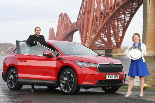 Scottish Car of the Year 2021 is the Skoda Enyaq, pictured at the Forth Rail Bridge, with Association of Scottish Motoring Writers president, Jack McKeown, with Kirsten Stagg, head of marketing atSkoda UK, receiving the Scottish Car of the Year title