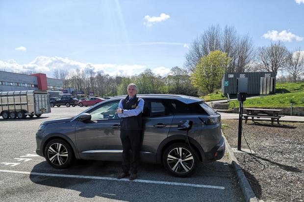 ANM CEO Grant Rogerson with one of the plug-in hybrid cars allocated to the group's staff