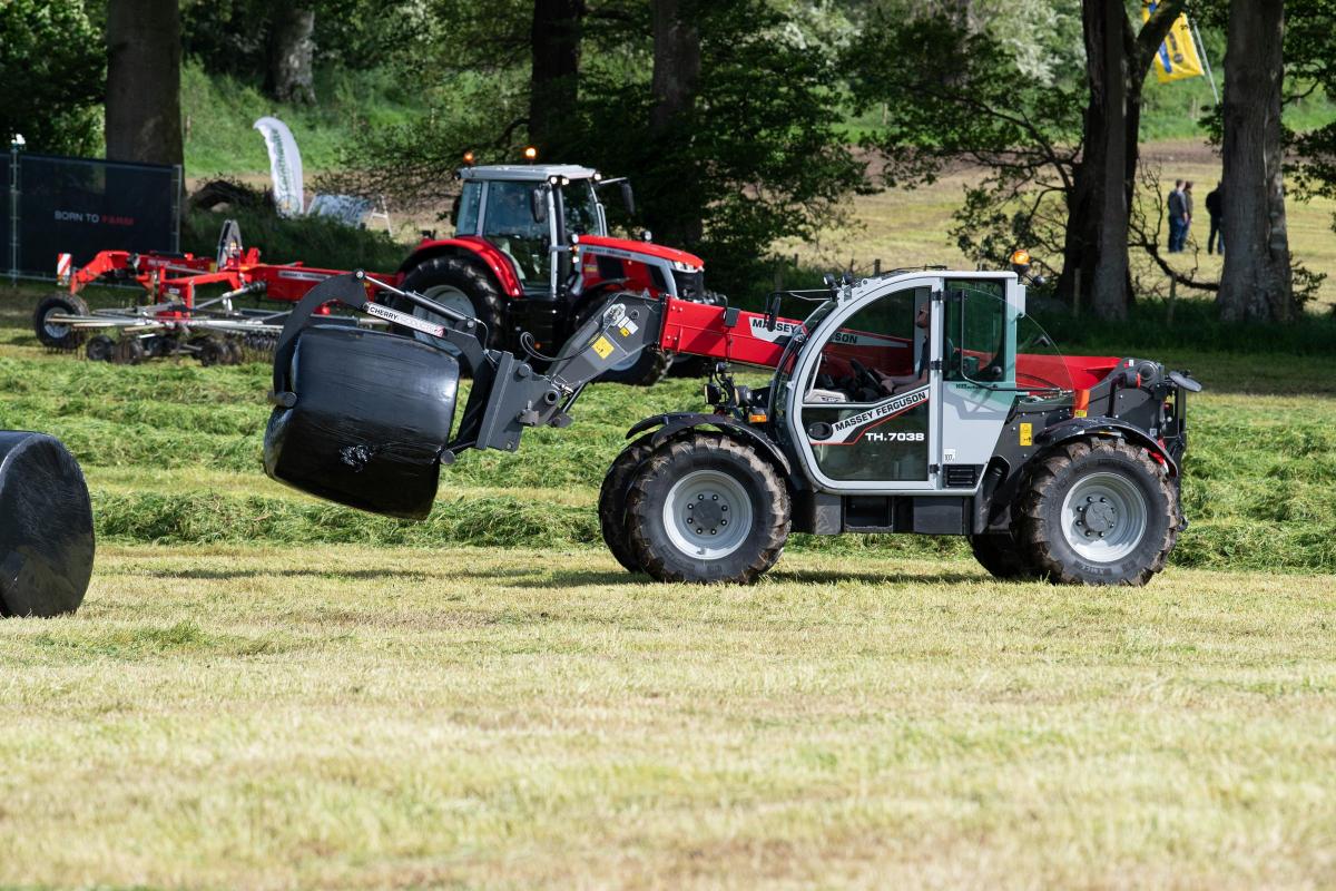 Massey Fergsuon's TH 7038 telehandler with Cherry Products over arm grab lifting wrapped bales during the demo  Ref:RH180522263  Rob Haining / The Scottish Farmer...