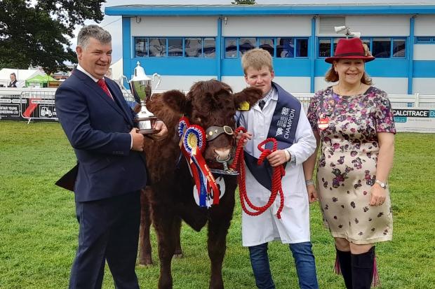 Lewis Ralston (14) won the inter-breed young handlers competition, pictured with judges Sarah-Jane Jessop and Dougie McBeath