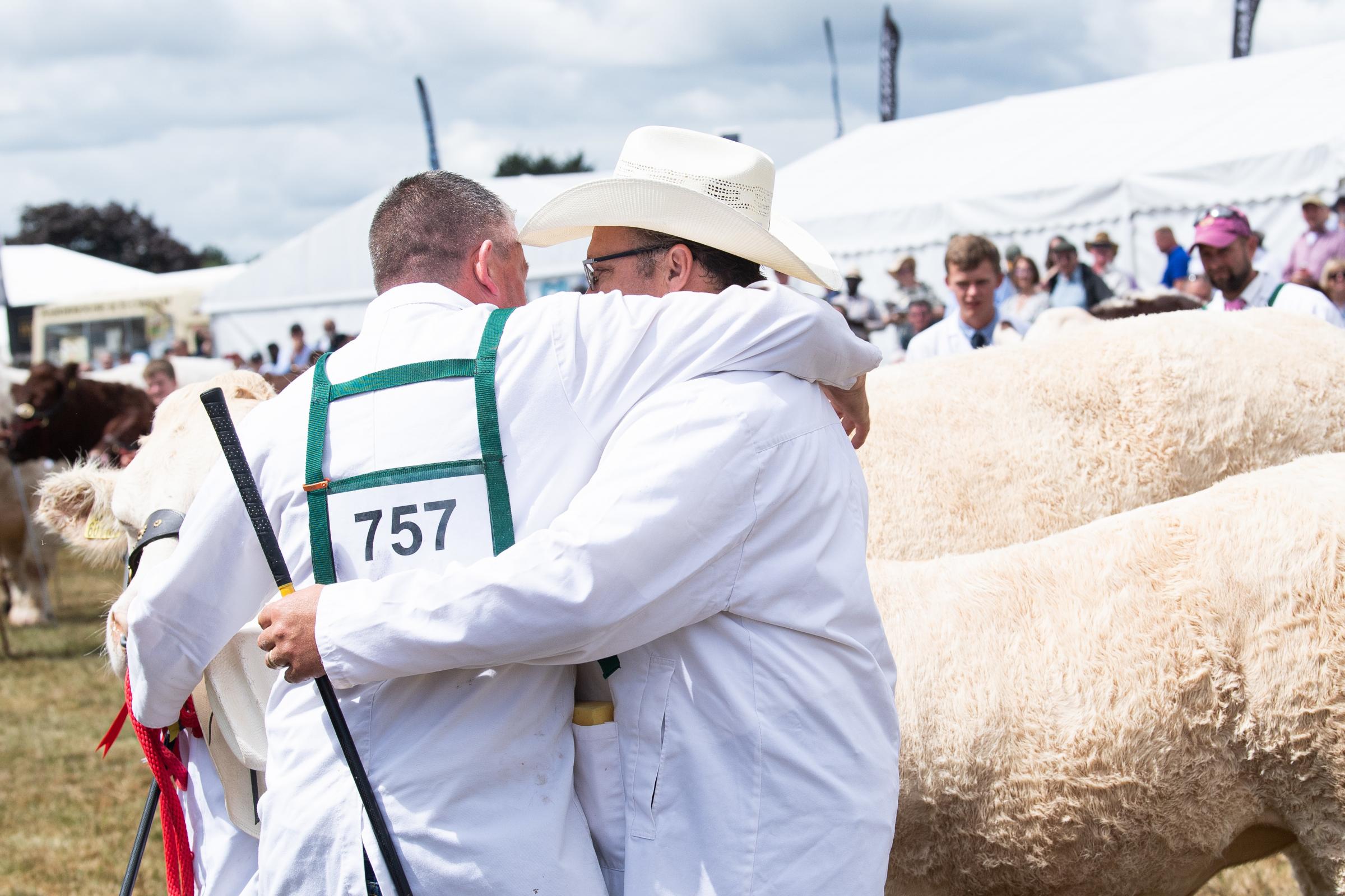 Steven OKane and Thor Atkinson celebrate winning the overall cattle with the Blonde, Brownhill Netta at the Great Yorkshire Show Ref:RH140722128  Rob Haining / The Scottish Farmer...