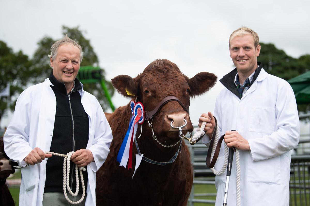 Rob and Iain Livesey and there over cattle champion Ref:RH230722034  Rob Haining / The Scottish Farmer...