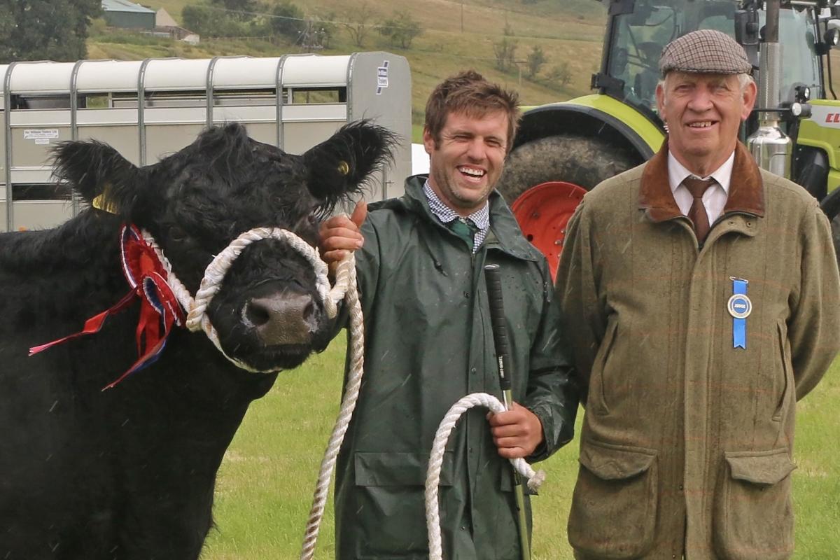 Iain Finlay with champion of champions judge Jock Peacock, and show topper, the ten-year-old Galloway cow, Dora May