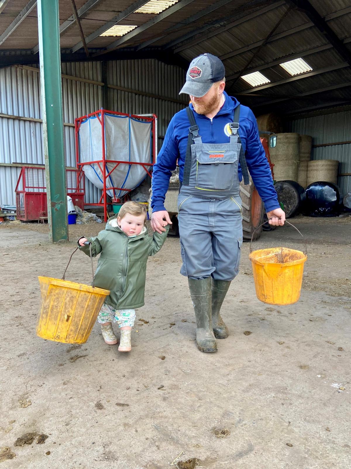 Rachel Hyslop - Time to feed the bull daddy. 16 month old Hannah and daddy Aly Young