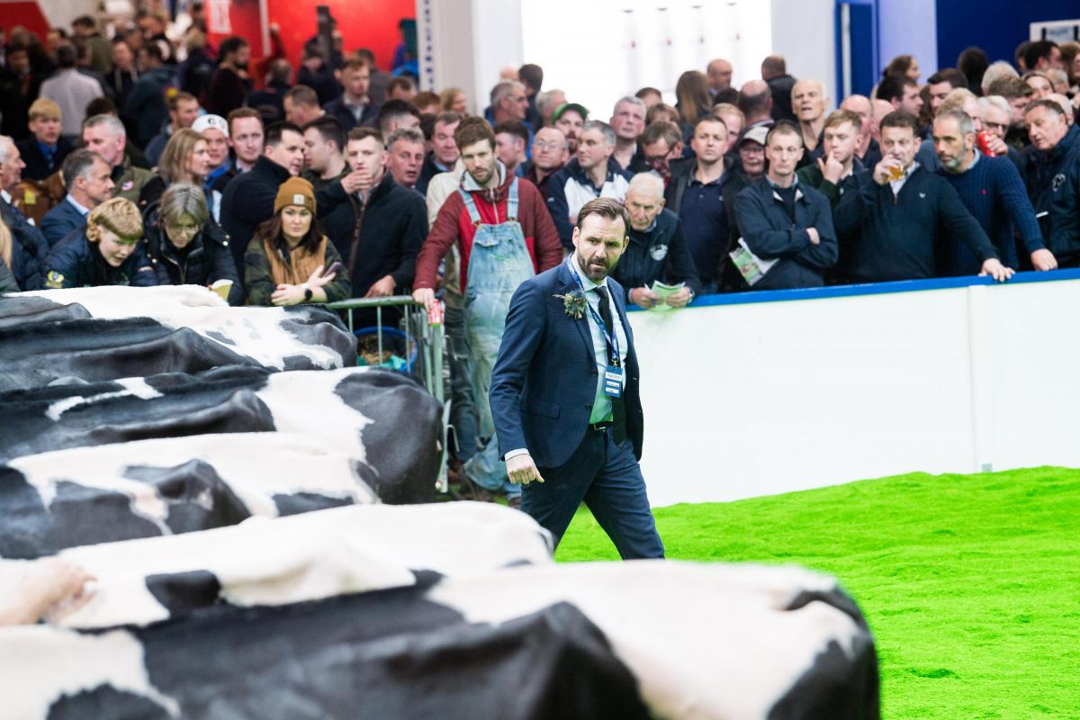 Crowd watch on as Niels Erik Haahr make his way round the Holstein entries Ref:RH161122090  Rob Haining / The Scottish Farmer...