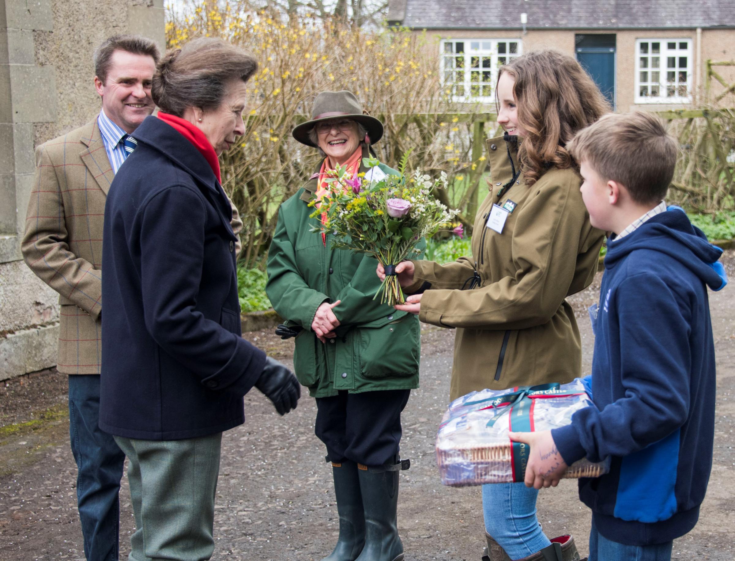 At Cowbog Robert with his mother, Joan, look on as HRH The Princess Royal is presented with gifts from Lottie and Henry Wilson