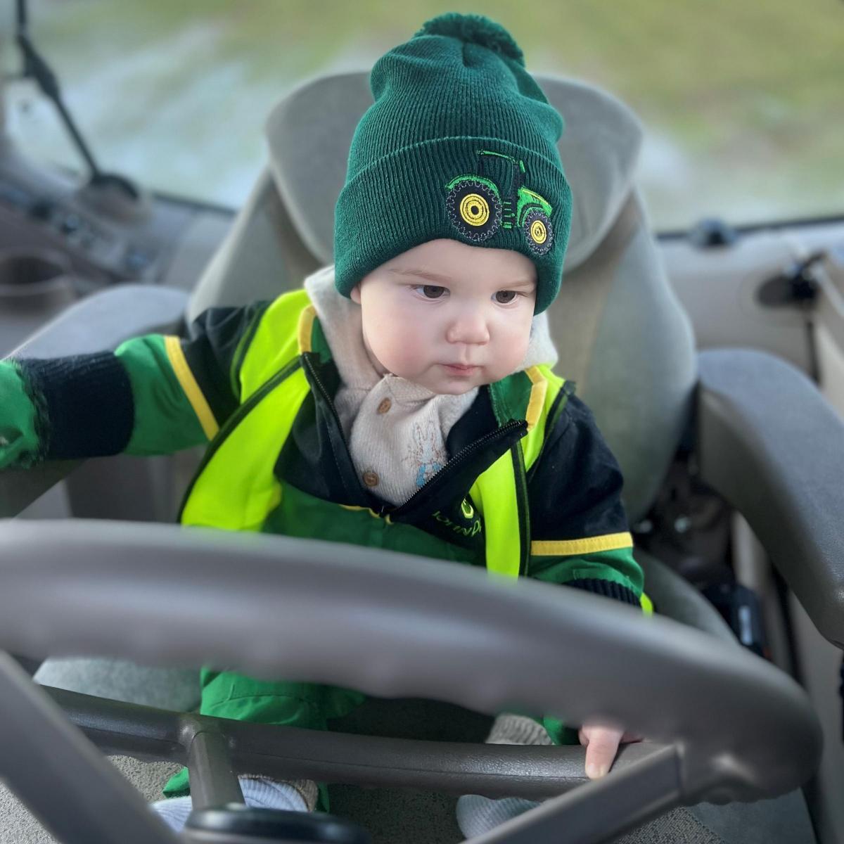 Eliza Faragher - 10 month old Angus, trying out his Pops new Deere! Really looks like he’s been driving tractors for years