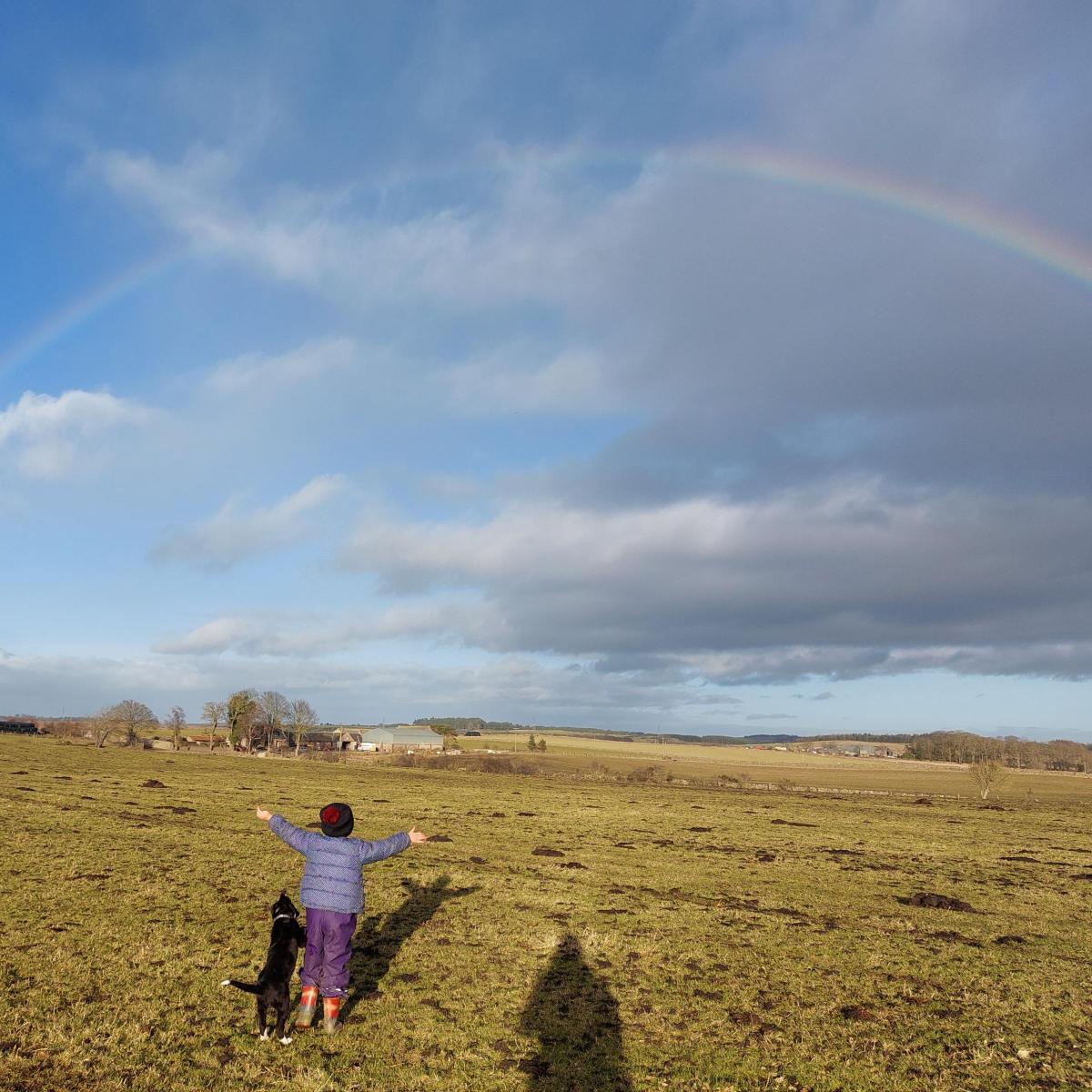 Nicola Youngson - Lucy Youngson aged 4 and her dog Meg admiring the rainbow at Westerton, Echt, Aberdeenshire