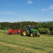 The sun shining in the summer months with a John Deere and Lely Hibiscus 915d rake