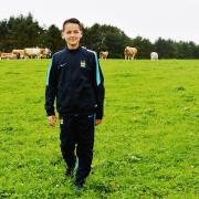 James Trafford pictured on his family's farm in Greysouthen aged 12