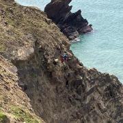 The coastguards in operation on the cliff edge at Marloes