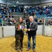 Shona Gunn is presented with the champion ticket by Eric Thomson