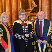 Linda Hanna, Anne Seaton and Wayne Powell with the Queen's Anniversary Prize medal