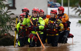 A rescue team makes their way through the flood waters on October 20, 2023 in Brechin Scotland