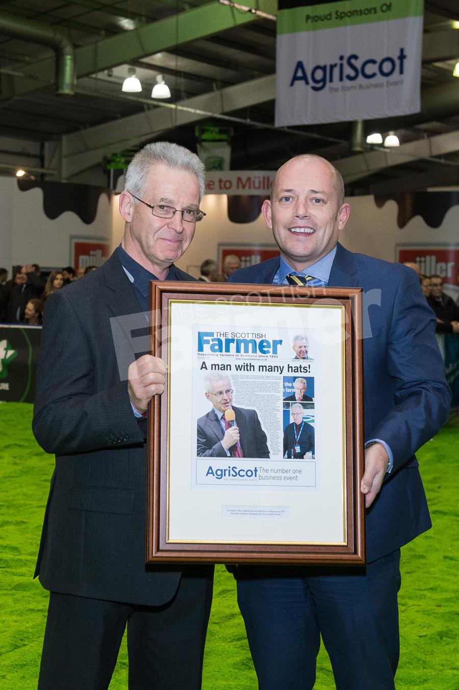 Andrew Moir is stepping down as Agriscot Chairman and Scottish Farmer Publisher Darren Bruce is presenting him with a framed gift. Ref: RH1511170198.