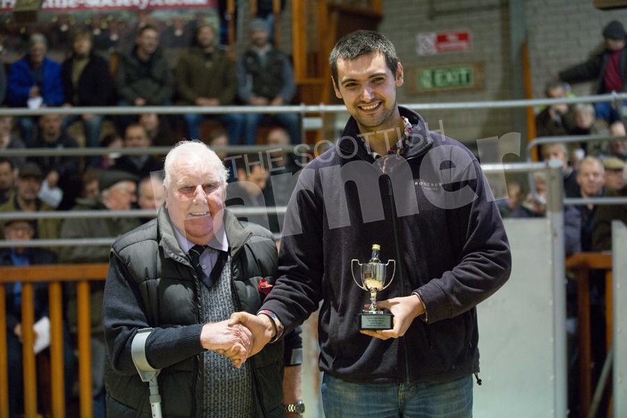 George Mcknight presenting James Cunningham 26 with the young stockman's award. Ref: EC0411172139.