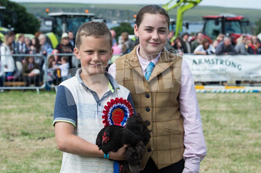 James(10) and Bethany(12) Swanson with their Perking Hen which stood champion in the poultry section. Ref: RH210718058.